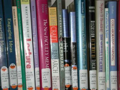 Books on shelf by computer